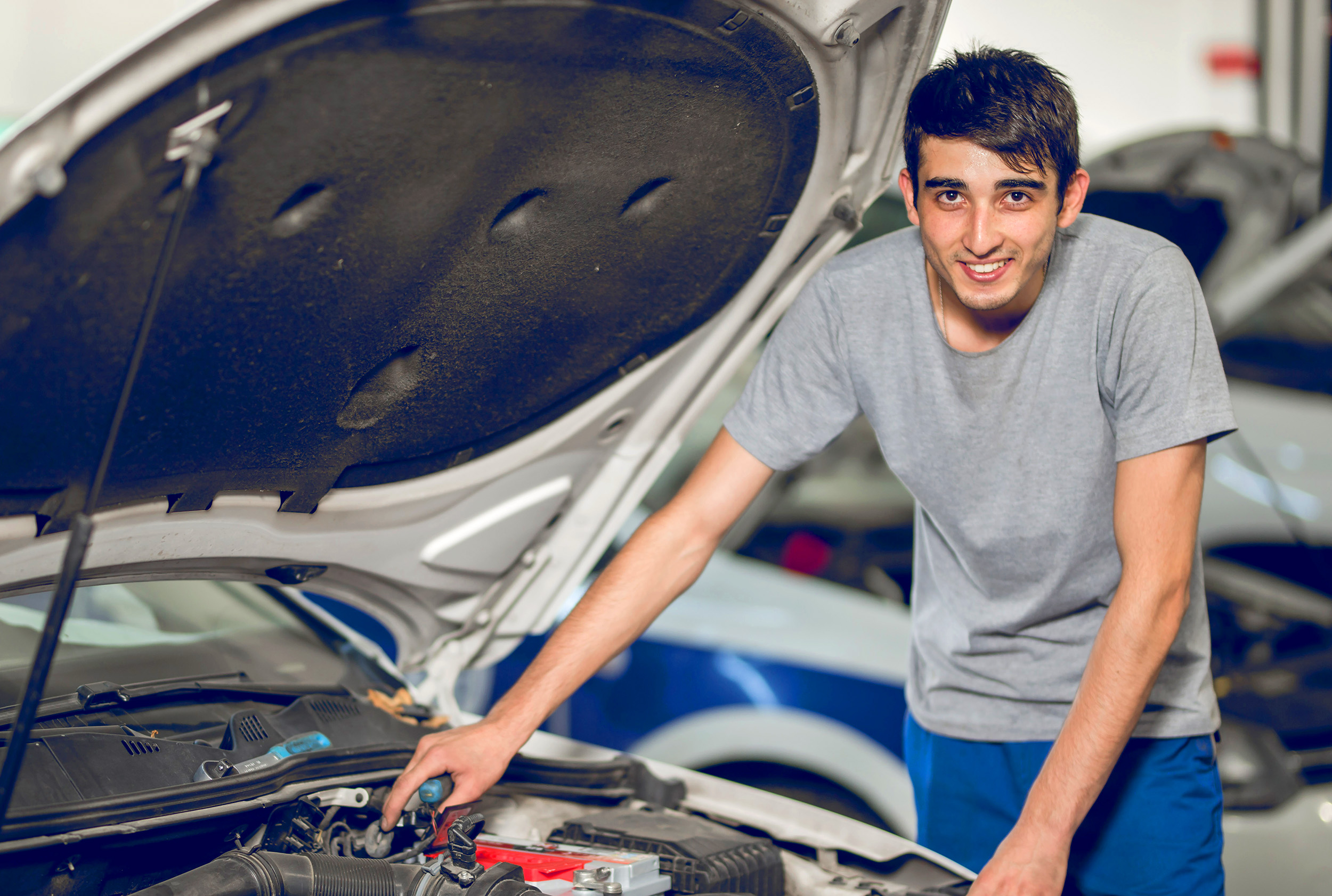 fellow benchman-reparing-engine-car